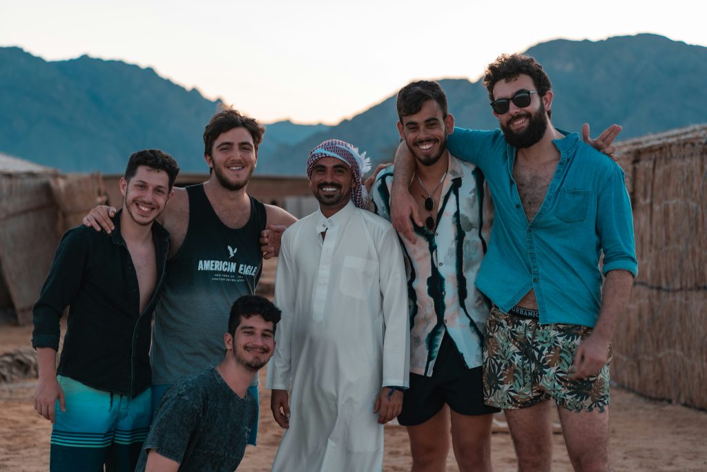 Diverse young Arabs gather, talk, and laugh together — belonging and connection