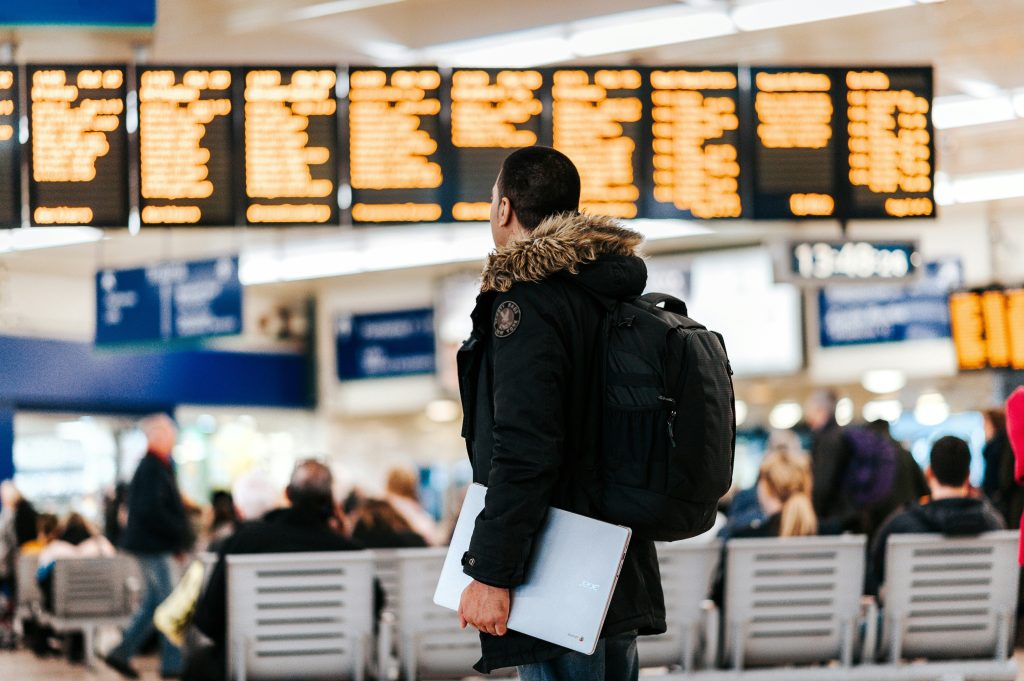 Traveler checking departure information board