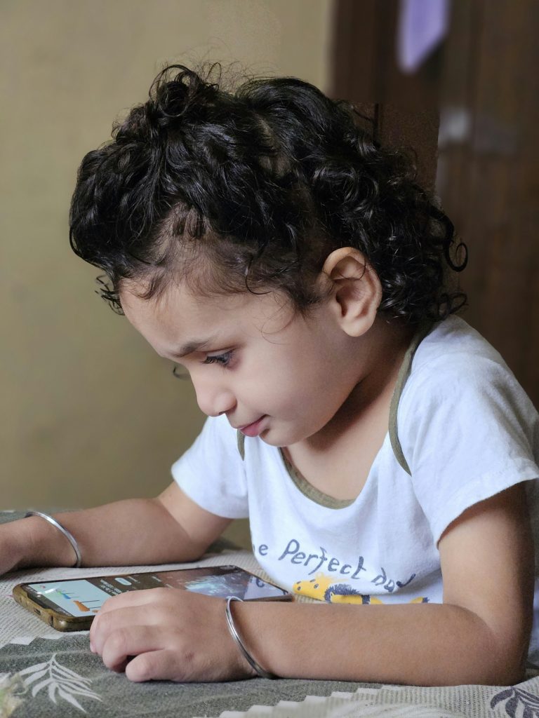 child cell phone learning app colorful Arabic language engaged