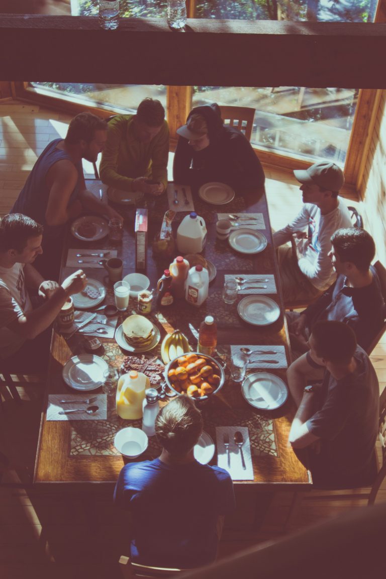 family dinner table conversation warm light three generations