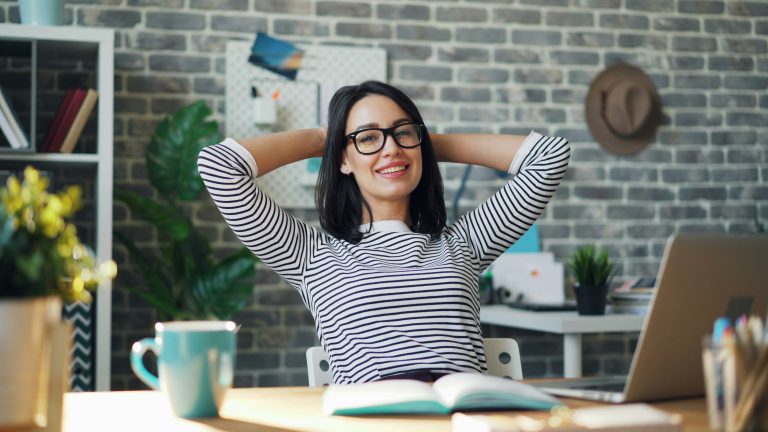 freelancer confident sitting desk calm financial peace of mind