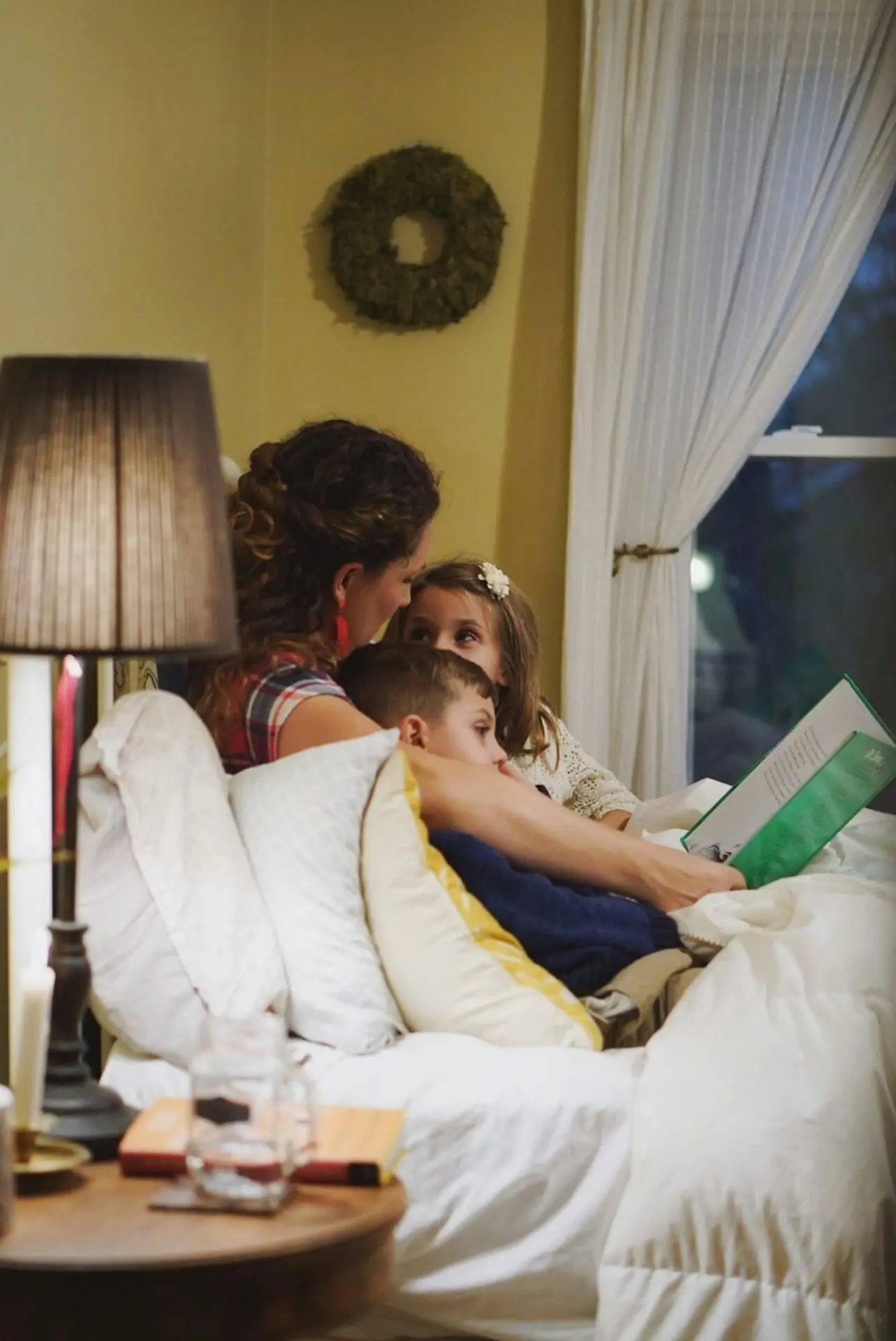 mother reading Arabic book child warm home