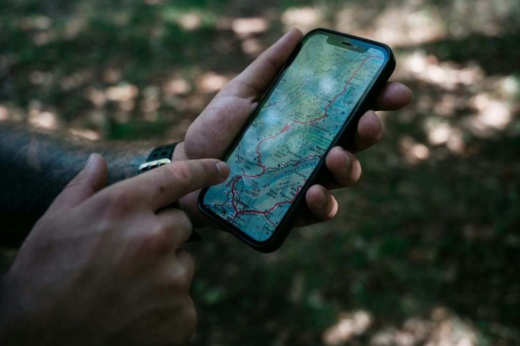 travel apps on smartphone screen with map background