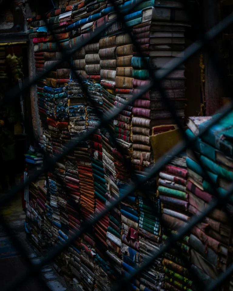 arabic prison literature books stack dark light