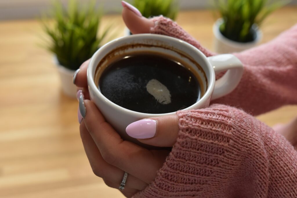 hands holding coffee cup warm