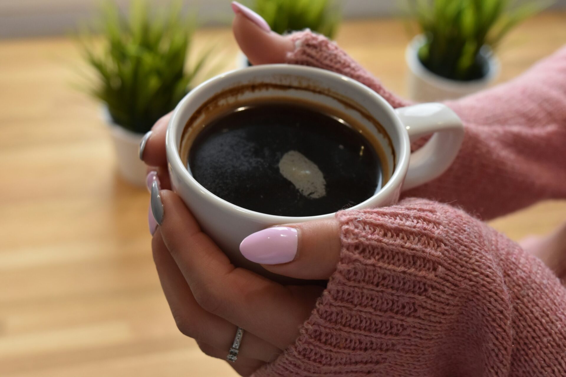 hands holding coffee cup warm