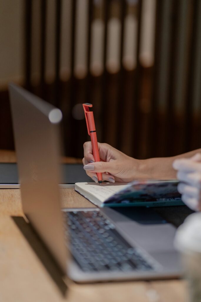 person reviewing editing paper red pen