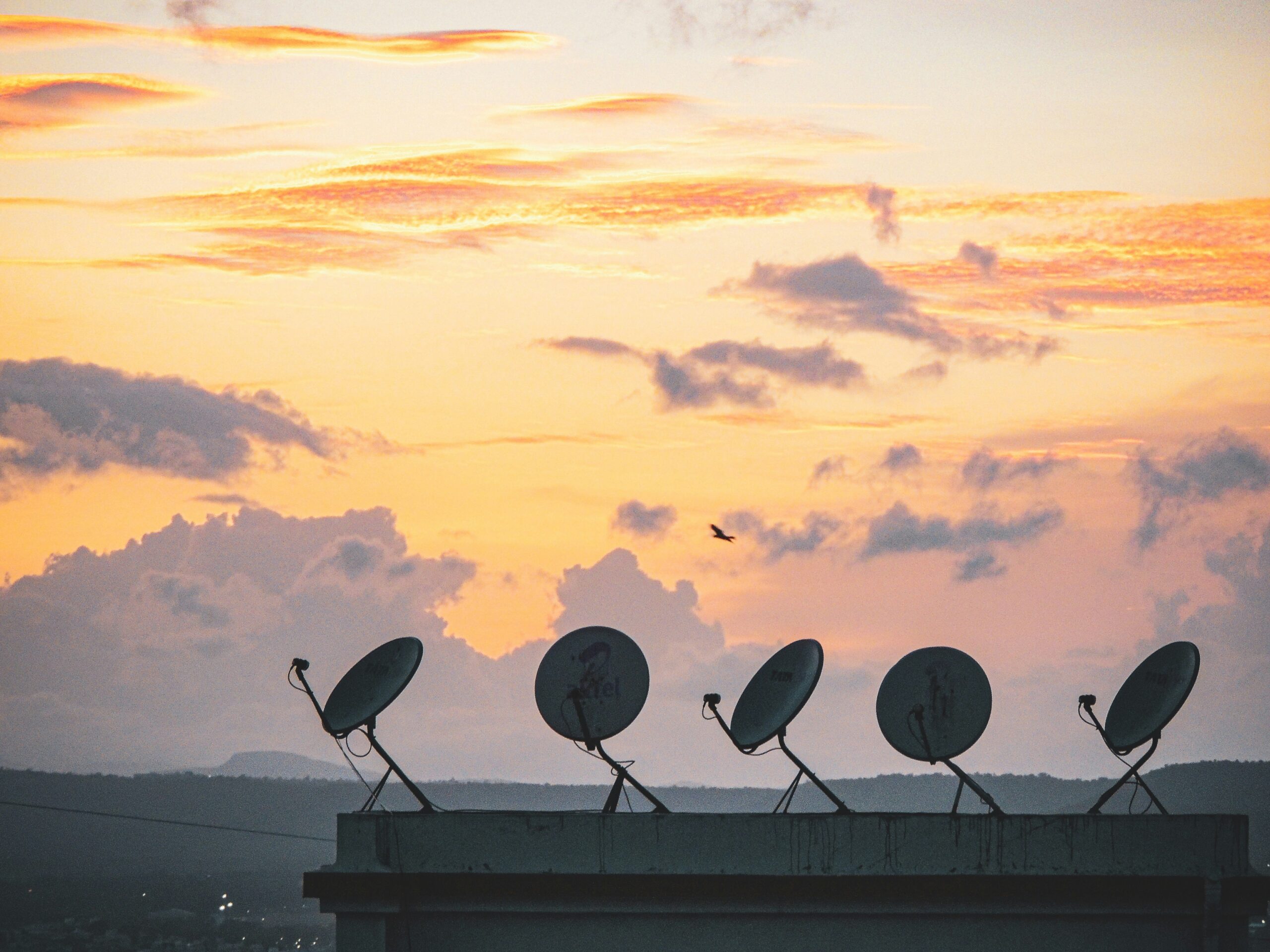 satellite dish rooftop city dusk