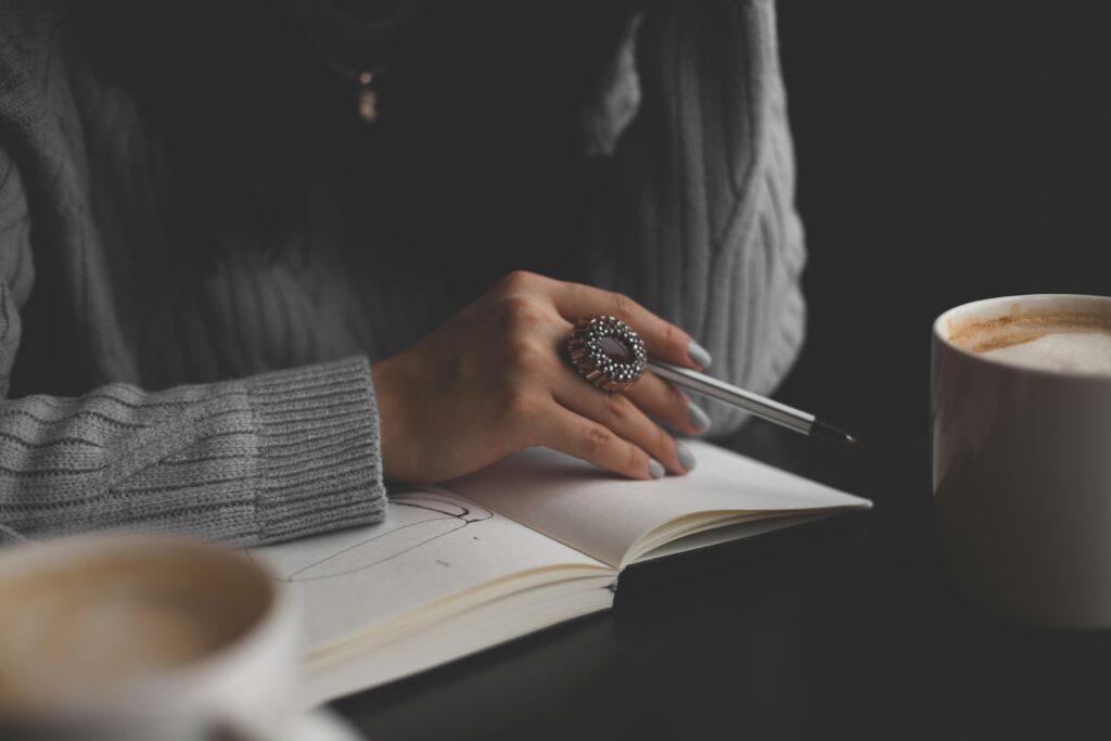 woman writing journal notebook coffee quiet