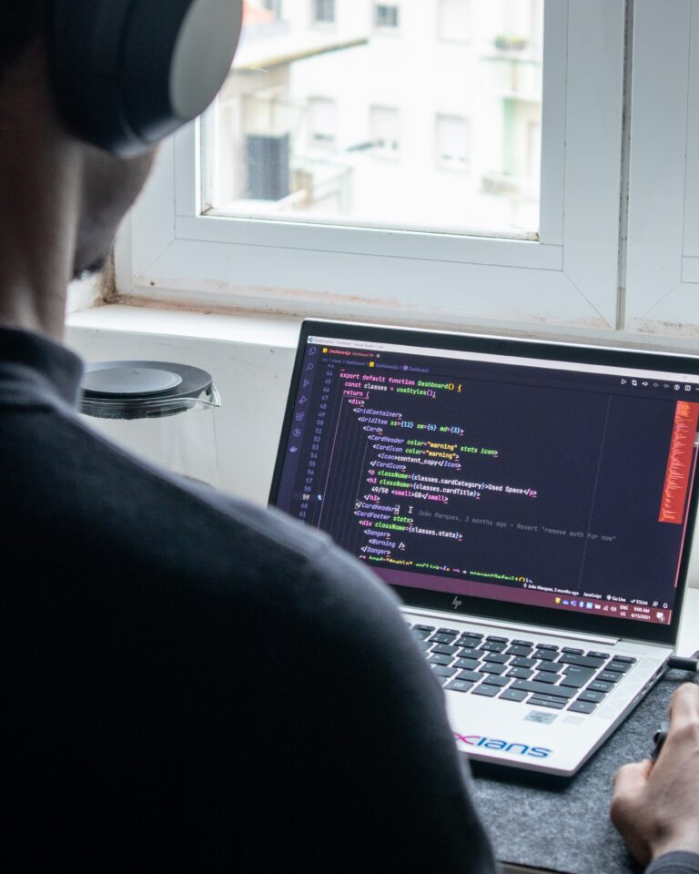 freelancer focused on coding python scripts on his laptop for task automation.