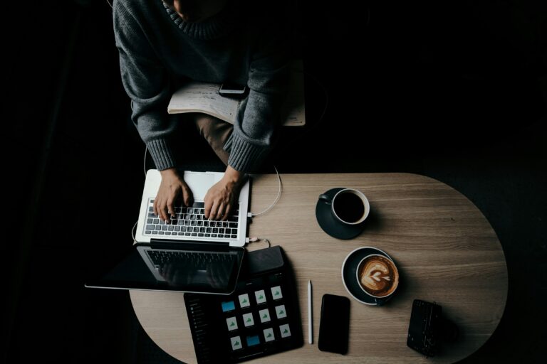 solo entrepreneur working laptop coffee productivity